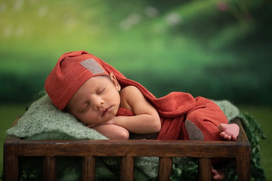 A baby sleeping on a cradle