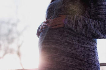 pregnant woman with sunshine in the background