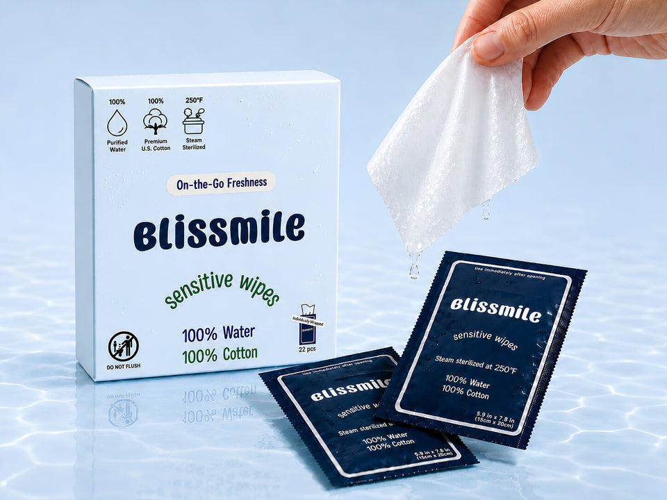 Blissmile Sensitive Wipes box, individually wrapped wipes, and a hand holding a moist cotton wipe